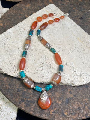 Antique Tibetan fluted carnelian beads are matched with silver capped carnelian beads and chrysocolla to give this necklace a lovely antique feel. Length 47 cm, pendant height 3.5 x width 2.2 cm