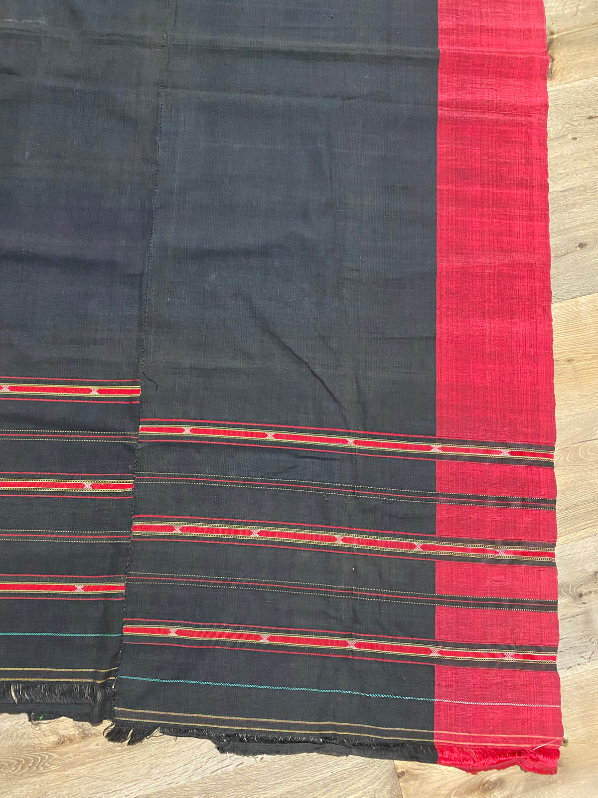Waziri men's shawl or chador, Northwest Frontier Pakistan/Afghanistan. Hand loomed in two pieces sewn together. Dark indigo/black cotton body is woven with red silk and a stripped patterned border as contrast. Early 20th C, most likely an heirloom piece used only once. In superb condition without blemish. 231 x 134 cm