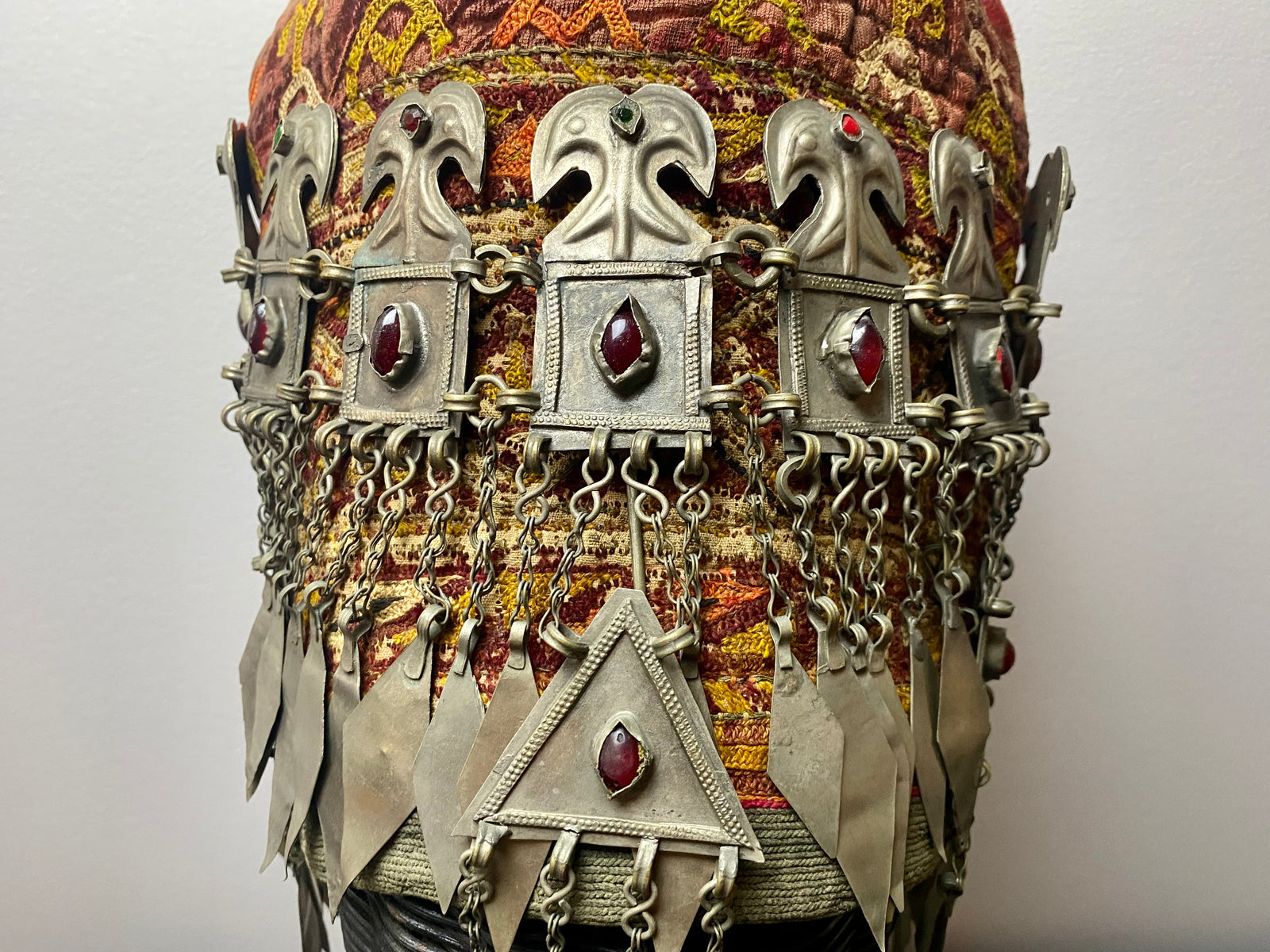 Ersari headdress consisting of a metal gaashbaagh & a high embroidered conical hat into which it attached with long spikes. The cap is quilted cotton covered in velvet and detailed silk embroidery. An heirloom piece, dating from 1870-1890. Cap height 23 cm. Tiara: width 53 cm, height of band 7 cm, side dangles 44 cm