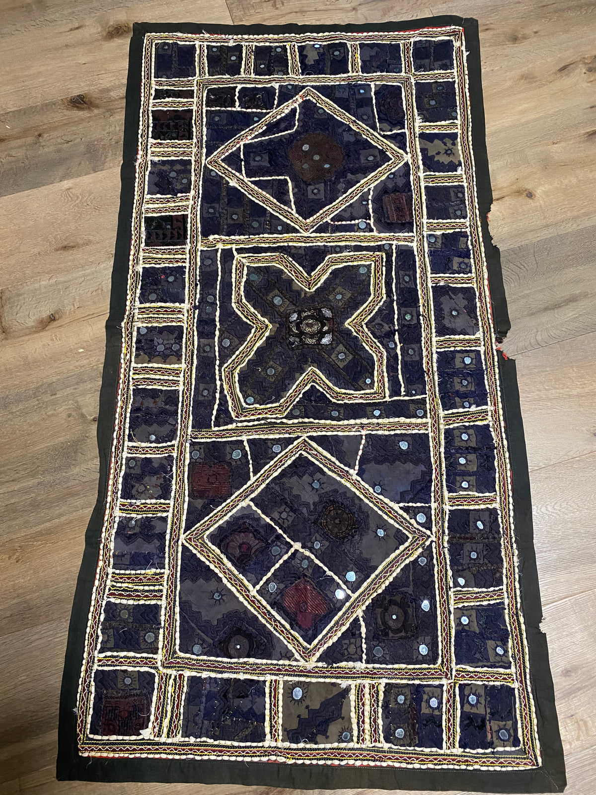 Authentic vintage Rabari textile featuring mirror-work, hand embroidery, applique and silver metal thread zari work. Mid 20th Century, from the Sind Desert region of Rajasthan. The textile is in excellent condition apart from some nibbles to the side of the textile. Measurements: 136 x 170 cm