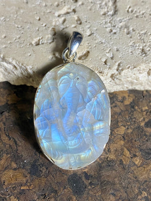 Hand carved rainbow moonstone pendants depicting Ganesh. These are unique pieces, with a beautiful luminosity enhanced by the depth of the stones. Sterling silver frame and bail. The bail is generous enough to allow a large chain or cord to pass through.