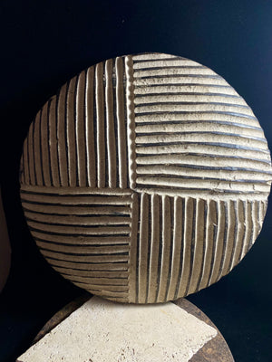 Round shield, Kuba people, vintage 1930's.  This shield features a patination of intersecting geometric lines and white pigment patina.  Measurements: diameter 42 cm, height approximately 6 cm