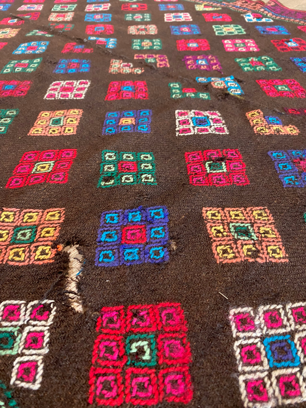 Yathra weaving, from the Chumey Valley in Bumthang, Bhutan. Hand spun and natural dyed yarn is backstrap woven into wool panels, then embroidered with wool thread. Mid 20th century. This textile is called a denkeb and was likely used as a rain cloak. Its condition is commensurate with its age. Measurements: 173 x 84 cm