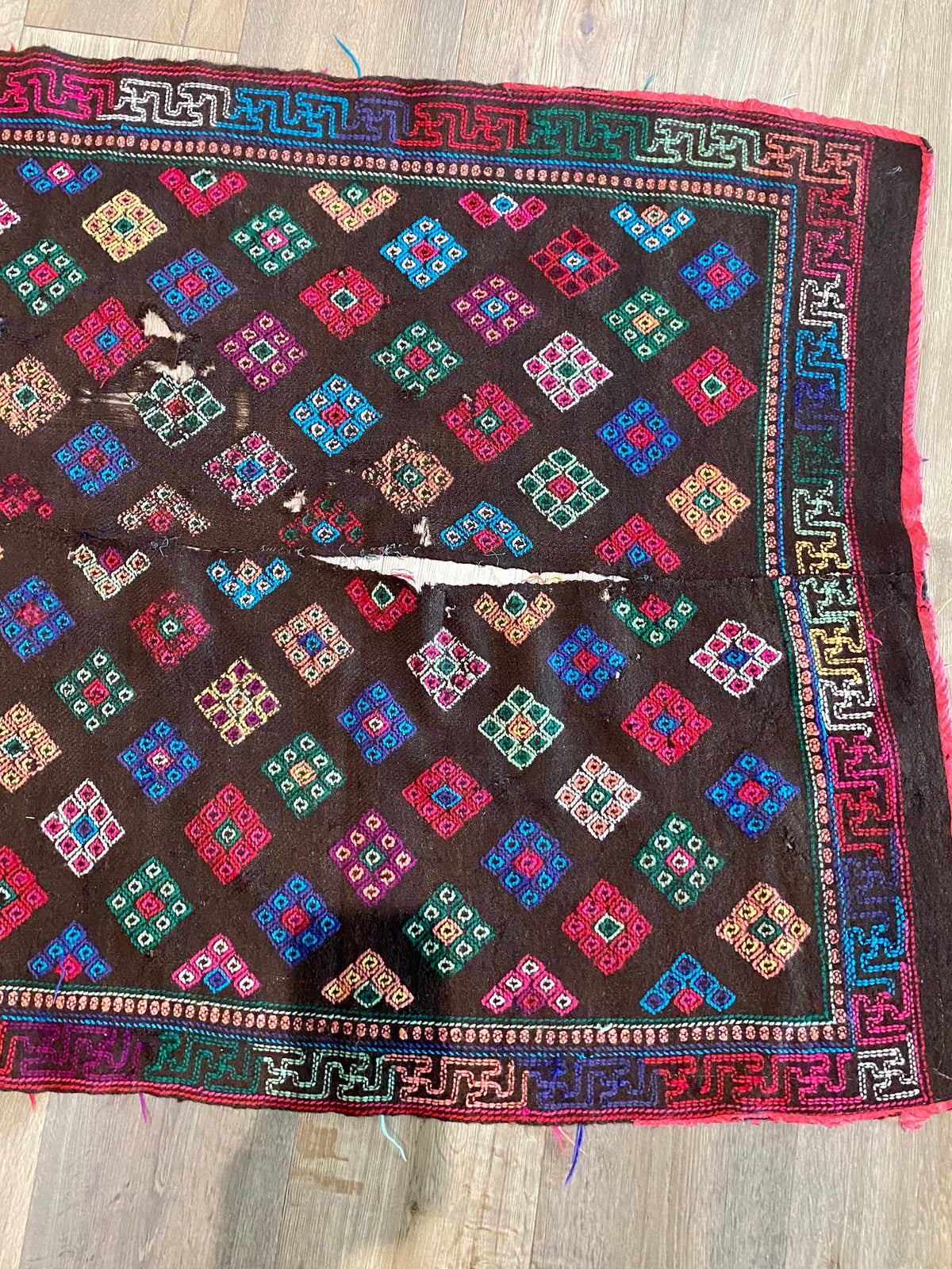 Yathra weaving, from the Chumey Valley in Bumthang, Bhutan. Hand spun and natural dyed yarn is backstrap woven into wool panels, then embroidered with wool thread. Mid 20th century. This textile is called a denkeb and was likely used as a rain cloak. Its condition is commensurate with its age. Measurements: 173 x 84 cm