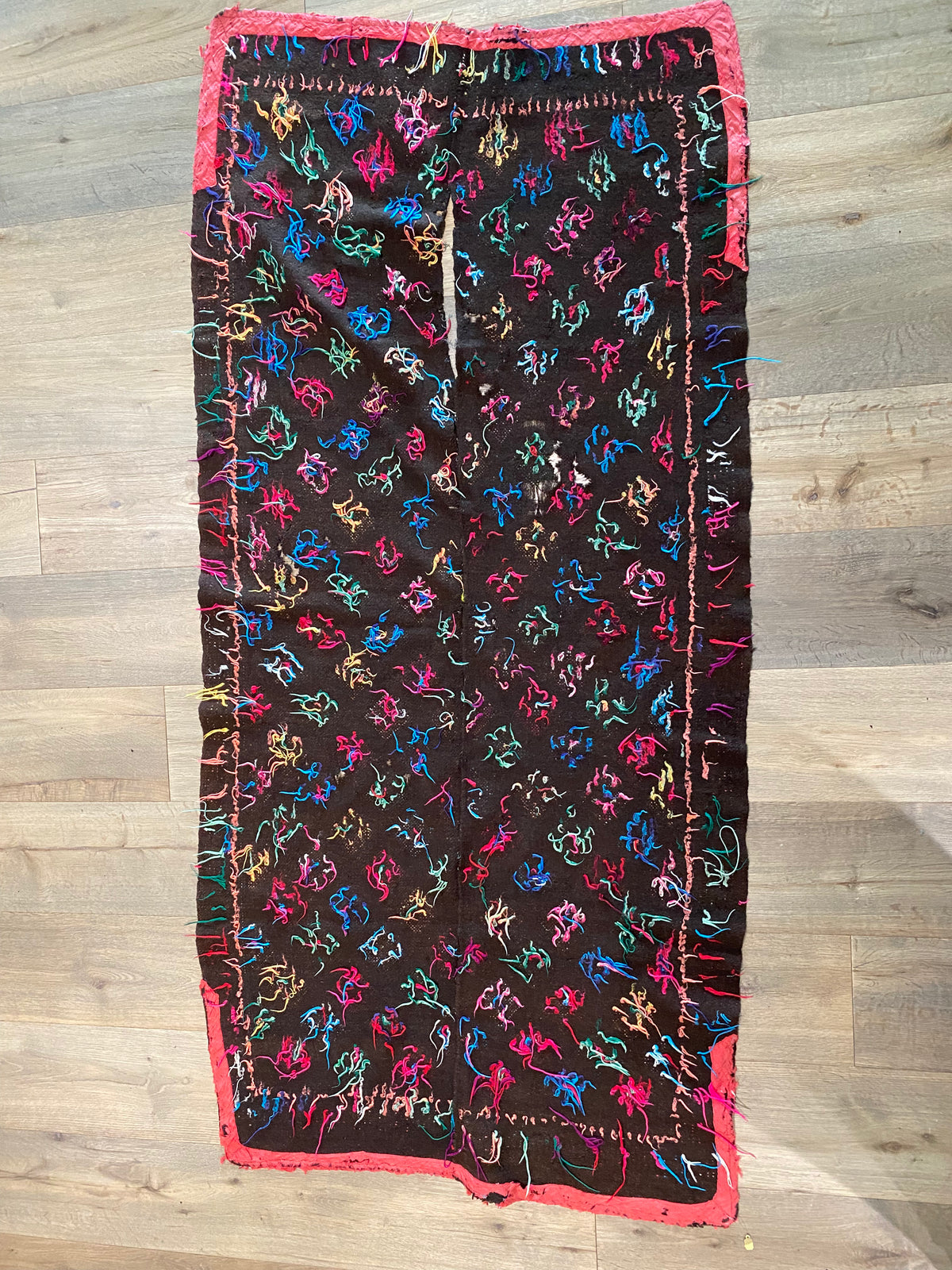 Yathra weaving, from the Chumey Valley in Bumthang, Bhutan. Hand spun and natural dyed yarn is backstrap woven into wool panels, then embroidered with wool thread. Mid 20th century. This textile is called a denkeb and was likely used as a rain cloak. Its condition is commensurate with its age. Measurements: 173 x 84 cm