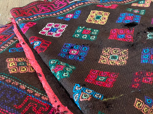 Yathra weaving, from the Chumey Valley in Bumthang, Bhutan. Hand spun and natural dyed yarn is backstrap woven into wool panels, then embroidered with wool thread. Mid 20th century. This textile is called a denkeb and was likely used as a rain cloak. Its condition is commensurate with its age. Measurements: 173 x 84 cm