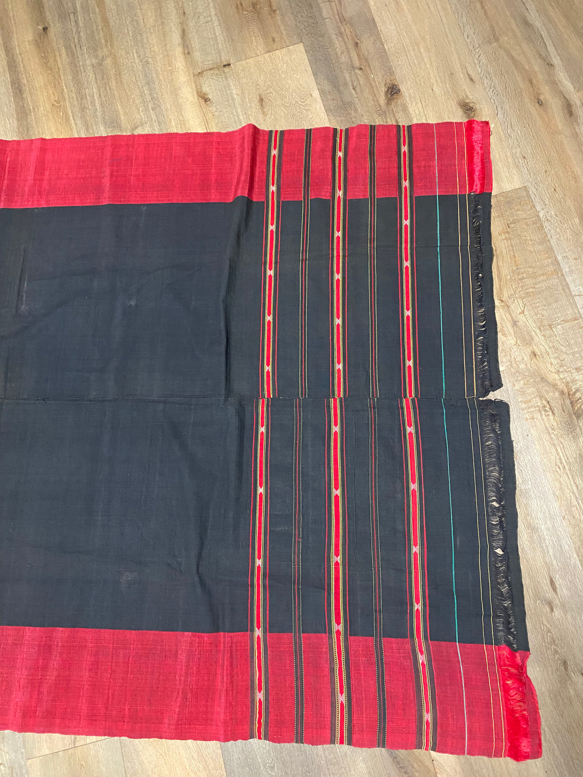 Waziri men's shawl or chador, Northwest Frontier Pakistan/Afghanistan. Hand loomed in two pieces sewn together. Dark indigo/black cotton body is woven with red silk and a stripped patterned border as contrast. Early 20th C, most likely an heirloom piece used only once. In superb condition without blemish. 231 x 134 cm