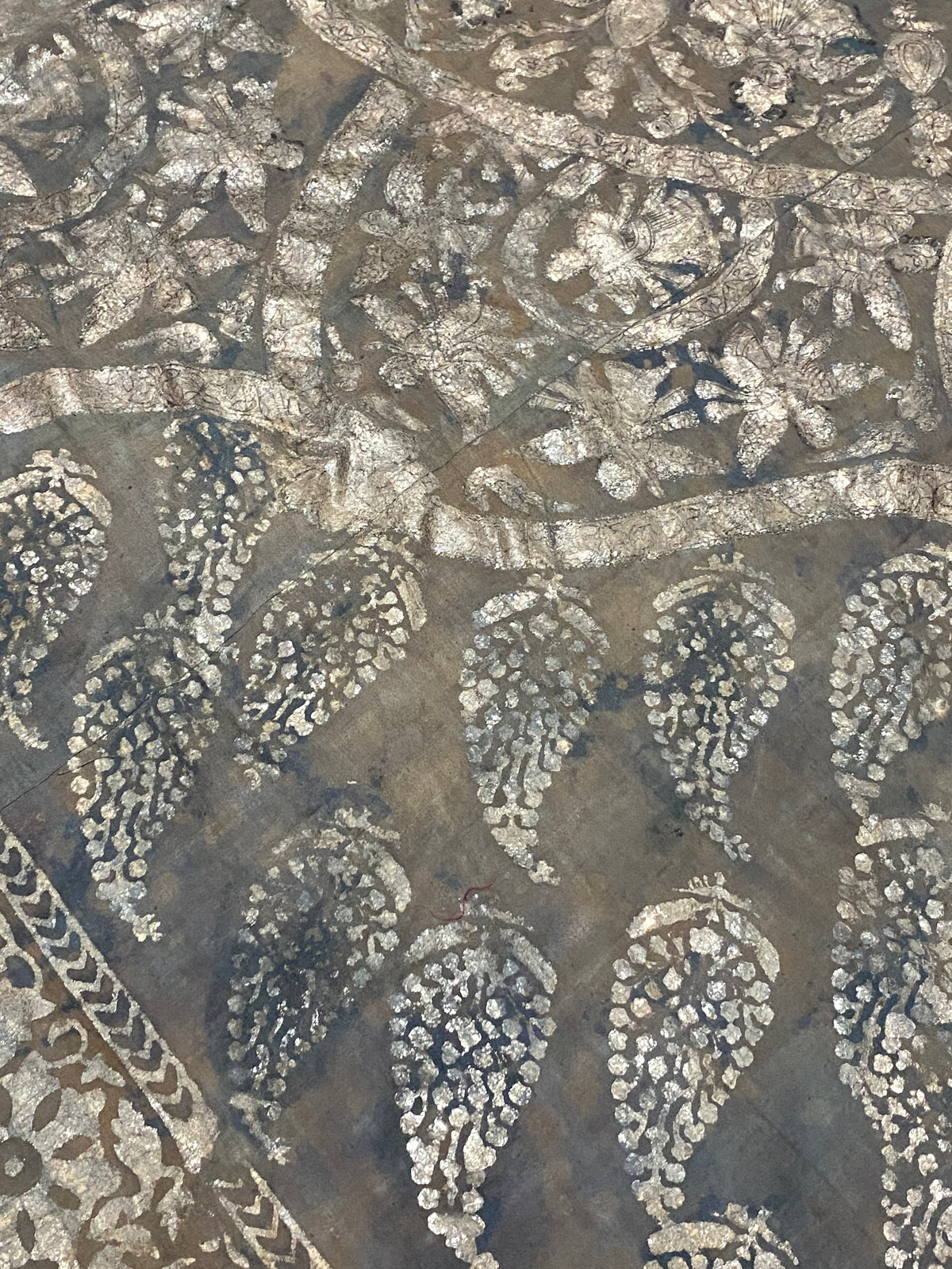 Pichwai temple hanging, silver leaf on a ground of handwoven cotton, featuring Krishna, gopis and apsaras. This devotional cloth hanging was made by Shri Nathji devotees of the Pushti Marg Sect. A large and rare circular-patterned example dating to late 19th Century and a collector's item. Measurements: 173 x 157 cm