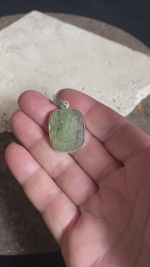 Unique, hand carved prehnite pendant depicting Ganesh. Sterling silver frame and bail. Measurements: height 3.6 cm including bail, width 2.1 cm. This is a unisex pendant and can be worn by men or women