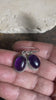 Amethyst earrings featuring high quality stones, classic darker cabochon amethysts with a detailed oval bezel. Sterling silver hook and mounts. Our amethyst earrings are open at the back to allow the natural light of the amethysts to shine through. Size 3.2 cm length including hook.