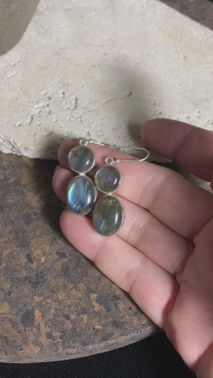 Large, oval labradorite earrings, crafted from cabochon labradorite stones set in sterling silver and finished with large hooks. Measurements: height 4.8 cm x width 1.2 cm