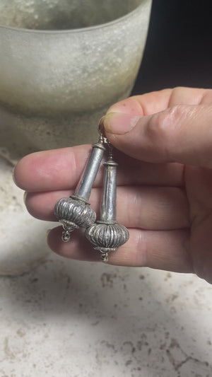 Antique silver beads resembling the mace (Gada) of Hanuman. Balances physical & spiritual energies, worshipped independently for its protective qualities as the goddess Kaumodakī. Sterling silver hooks & components, light to wear. Length 5.7 cm