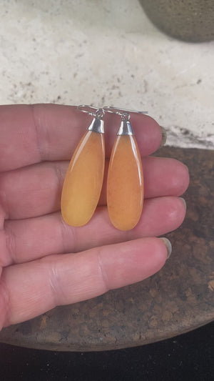 Translucent orange flat teardrop jade earrings set in stylish sterling silver mounts and hooks. Lightweight and easy to wear. 5 cm length including hook, width 1.2 cm at widest point 