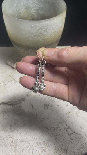 The silver that makes up these tribal earrings are a combination of high grade silver antique beads sourced by us many years in Pakistan and India. They feature 925 sterling silver hooks and are light and easy to wear. They will appeal to anyone with a taste for the beautiful and unusual. Measurements: 4.7 cm length including hook