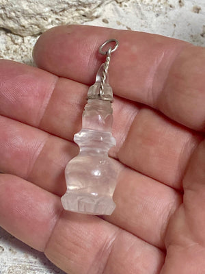 Hand carved rock crystal stupa pendant. Top mounted sterling silver bail. From Nepal. Measurements: height 5 cm