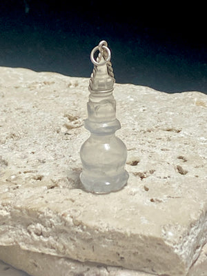 Hand carved rock crystal stupa pendant. Top mounted sterling silver bail. From Nepal. Measurements: height 5 cm