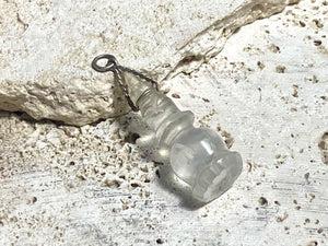 Hand carved rock crystal stupa pendant. Top mounted sterling silver bail. From Nepal. Measurements: height 5 cm