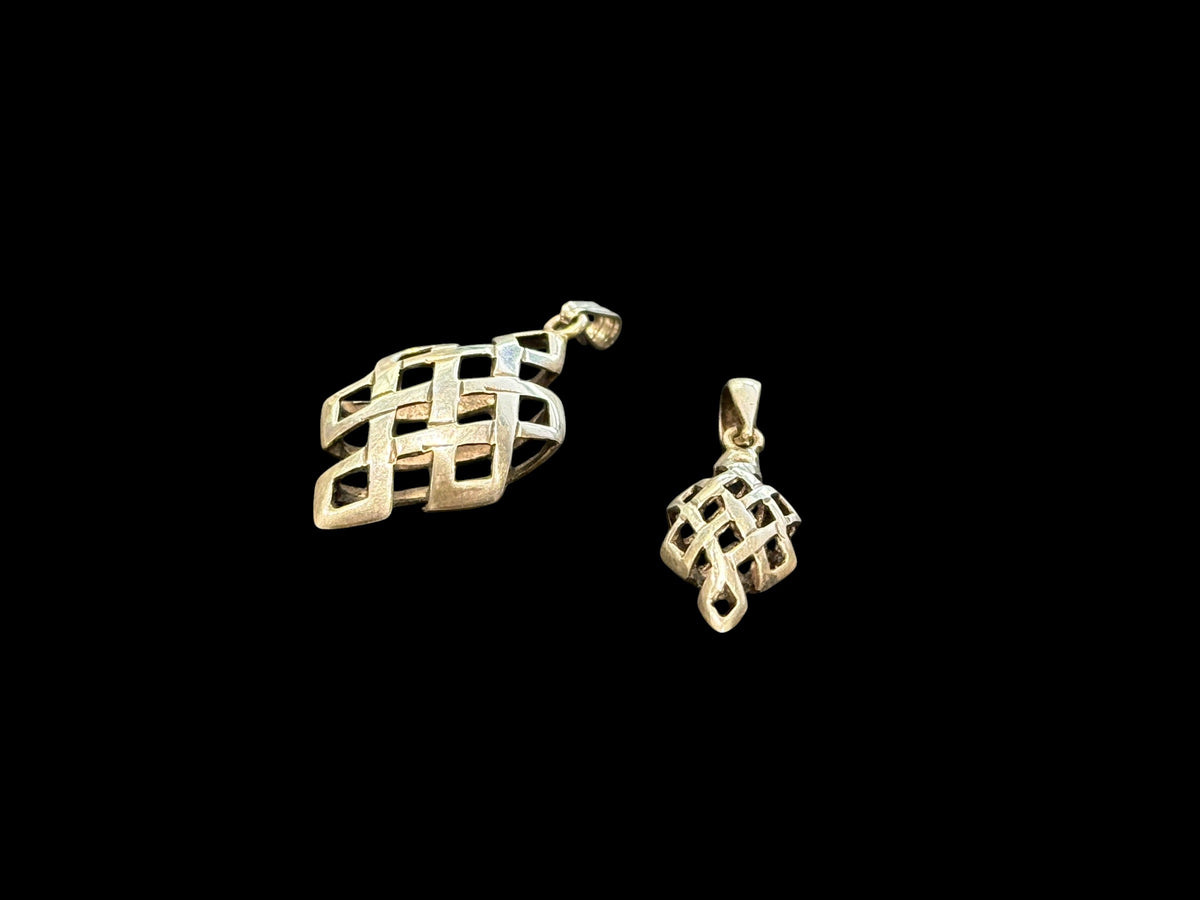 Striking silver Endless Knot pendants, one of the eight auspicious symbols of Buddhism. Sterling silver, in two sizes. 