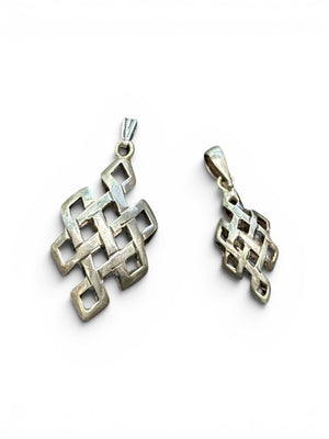 Striking silver Endless Knot pendants, one of the eight auspicious symbols of Buddhism. Sterling silver, in two sizes. 