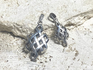 Striking silver Endless Knot pendants, one of the eight auspicious symbols of Buddhism. Sterling silver, in two sizes, from Nepal