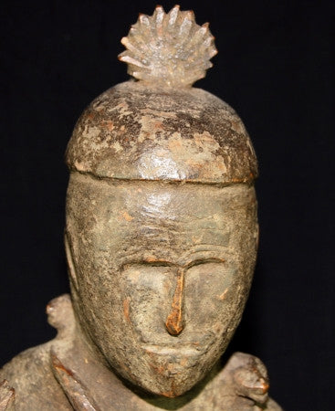 Naga antique tribal statue, an ancestor figure with right hand raised in protection, head adorned with plumed cap. Two snakes are wrapped around the torso, their heads resting on the shoulders, dressed in a fringed kirtle. 19th C or earlier, well preserved with an aged patina. Height 56 cm, width 16.5 cm, depth 15 cm