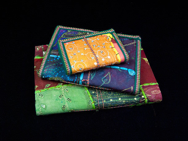 Eco-friendly sari cover journal notebooks are filled with creamy white, handmade recycled notebook paper and are covered in a patchwork of old cotton sari textiles, all finished with cotton, thread and sequin detailing. Three sizes