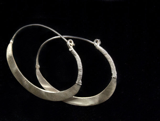 Beautiful hand beaten sterling silver hoops with wrapped silver wire detailing.  Waziri, from Afghanistan.  Measurements: outside diameter of hoop approximately 4.6 cm