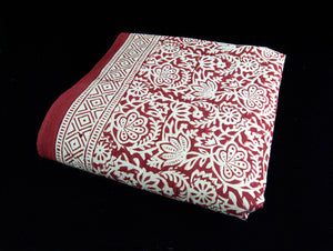 Red block printed organic cotton tablecloth featuring natural dyes and a bold white and red floral and geometric pattern