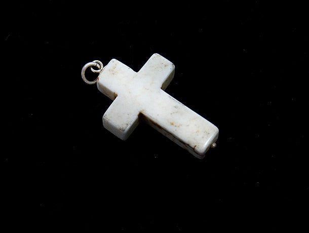 Howlite stone cross pendant, with sterling silver mount and ring bail, and a tiny silver ball detailing at the base of the cross. Thick cut and chunky in design, this would look great on a silver chain or a leather cord. Suitable as men's jewellery or women's jewellery.