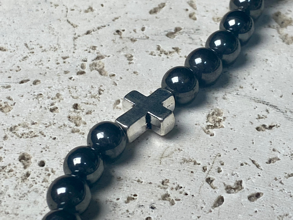 Beautiful unisex hematite necklace of perfectly cut round beads highlighted with a silver cross and sterling silver hook clasp. Can be worn by men or women. Length 50.5 cm