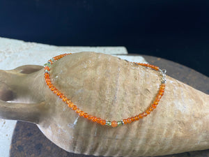 Beautiful anklets featuring natural carnelian, peridot and sterling silver charms. Sterling silver clasps and detailing. Designed to sit gracefully around the foot rather than tight to the ankle. Select from three sizes.