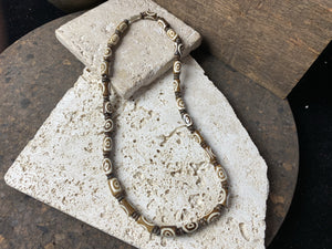 Beach vibe surfer necklace made from brown etched cow bone tube beads and coconut wood spacers with brass screw clasp