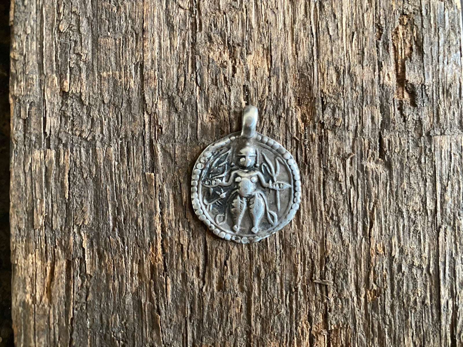 Antique silver amulets representing the Hindu god Kali, in her protective form, and dating from the early 19th - early 20th century.  Measurements: all vary between 1.5 and 2.2 cm in width