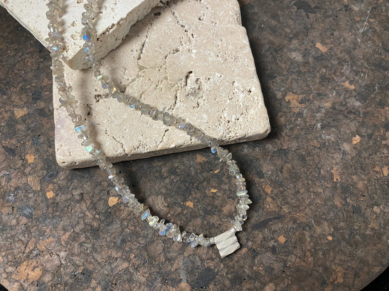 Necklace of rounded labradorite chip stones highlighted with sterling silver spacers and set with a beautiful silver tribal pendant. %0 cm length