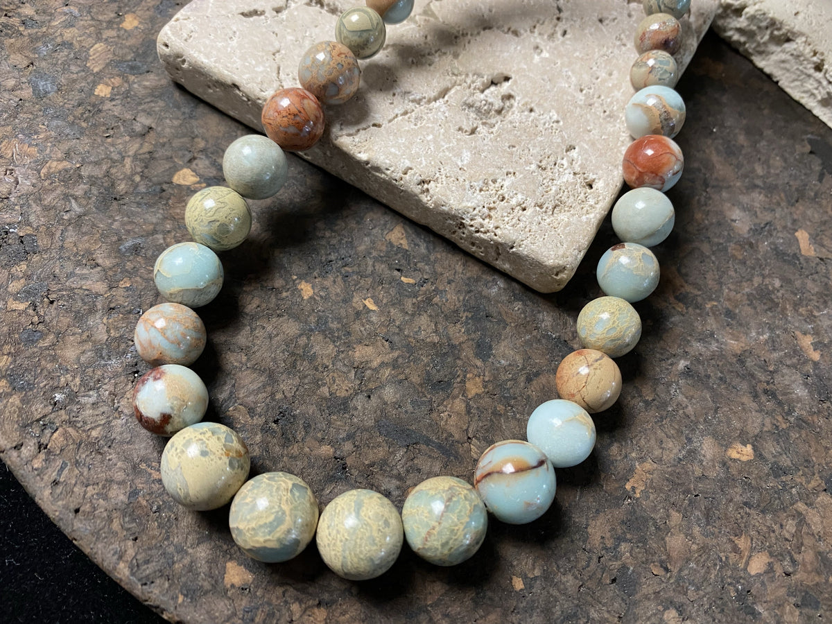 A long necklace made from perfectly matched, graduated Ethiopian opal beads, finished with sterling silver findings. Hook clasp. Measurements: 80 cm (31.5"), largest bead 14 mm diameter, smallest bead 6 mm diameter.