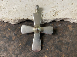 19th century Ethiopian silver crucifix, cut from a Marie Therese silver thaler. Raised button decoration on front side, plain back. Very heavy wear at the head of the bail.  A wearable and collectable antique silver cross. Measurements: length 7.2 cm (3"), height of raised decoration 1 cm