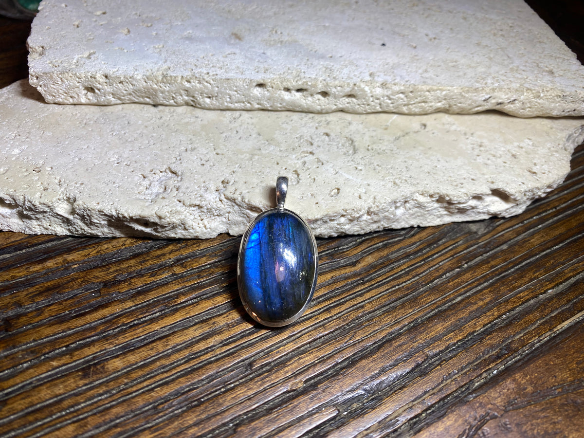 Stunning mid size oval labradorite pendant set in sterling silver with a generous bail to take a large chain or cord. A high set stone with excellent blue colour and fire.