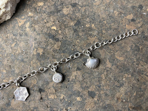 Sterling silver charm bracelet with 6 charms including elephant, dragonfly and seashell, with plenty of room to add more charms. With extension chain