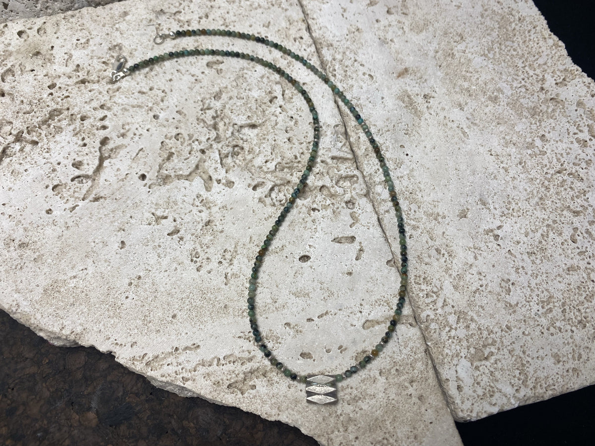 Very fine stone women or mens necklace made from tiny Ethiopian opal beads, highlighted with Karen silver "eye beads" and tribal pendant. The effect is simple, understated and stunning. Finished with sterling silver findings and clasp. A unisex necklace. Length 46.5 cm (18.35")