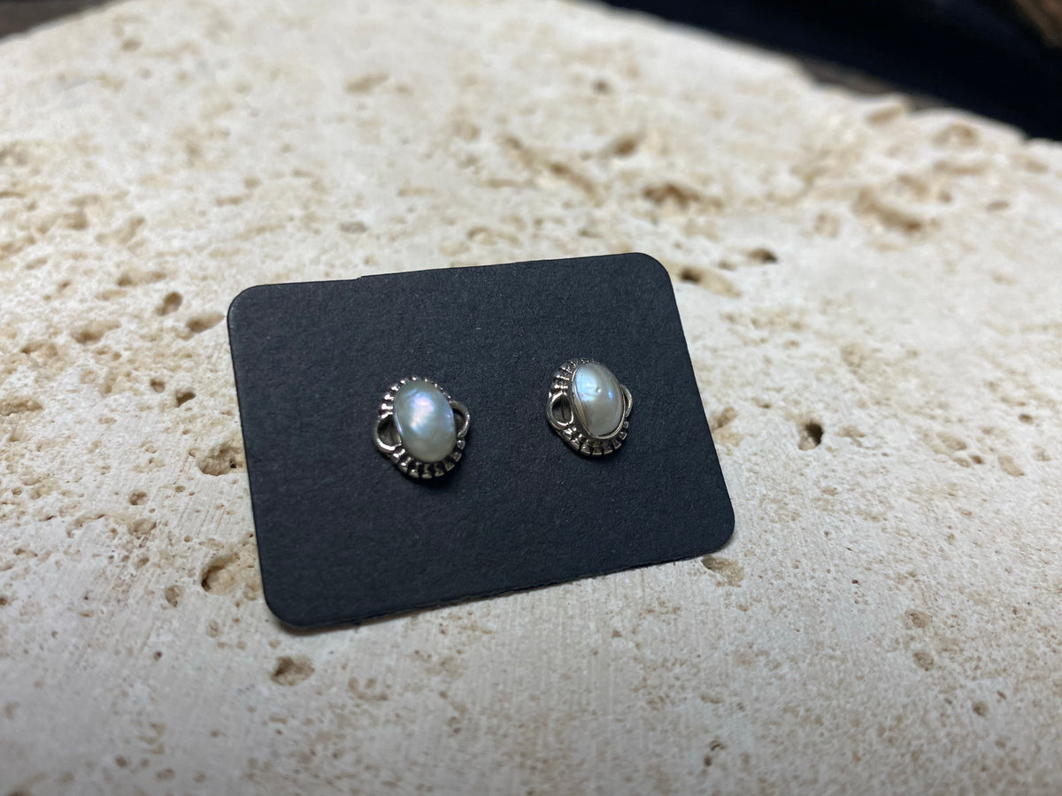 These small pearl studs are hand made from sterling silver and set with natural pearl cabochon stones