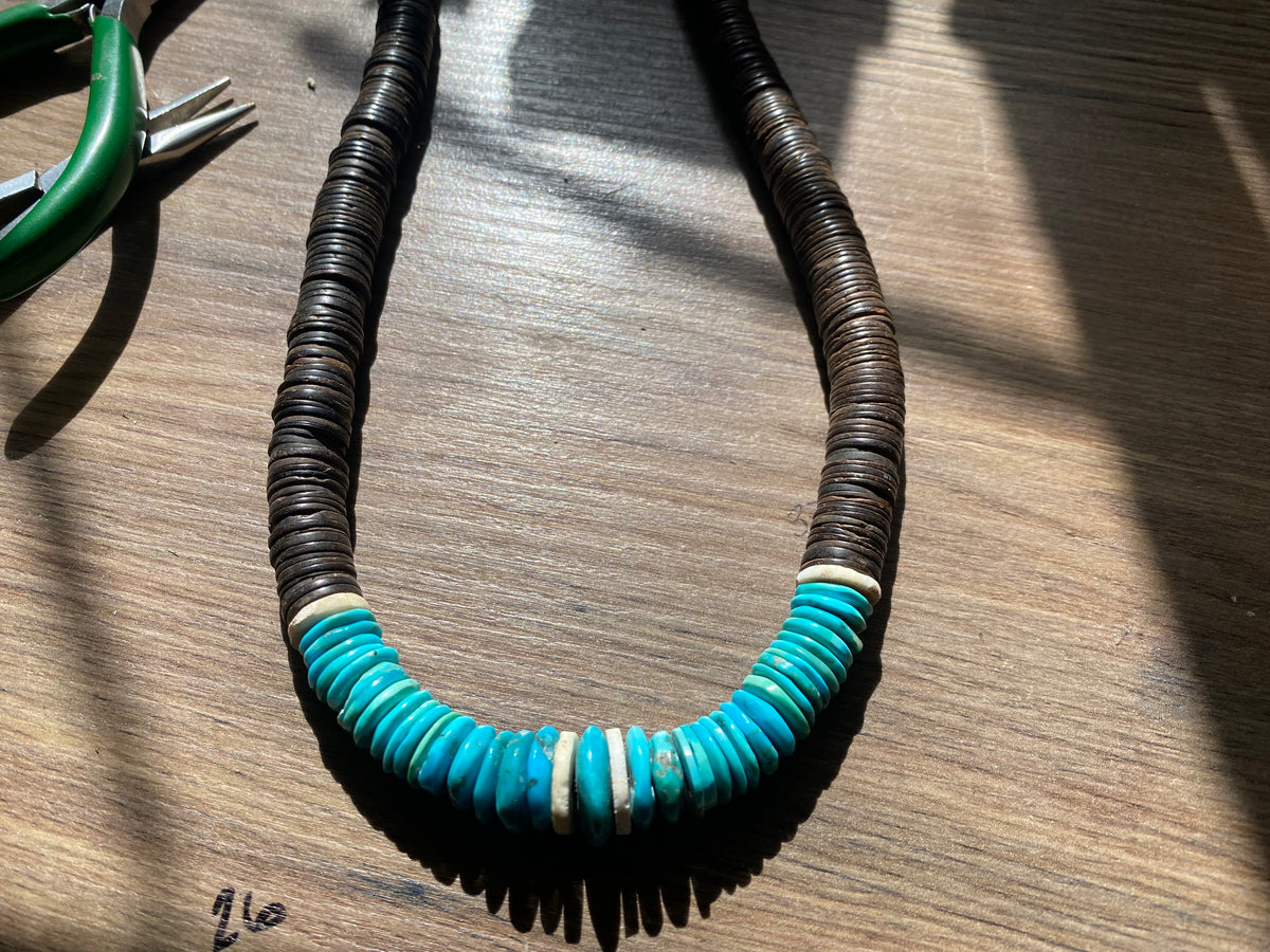 Statement necklace with an African vibe. Made from vintage wood heshi beads and Arizona turquoise, highlighted with vintage ostrich eggshell beads. The necklace is finished with handmade silver cone ends and a generous hook clasp. length 57 cm