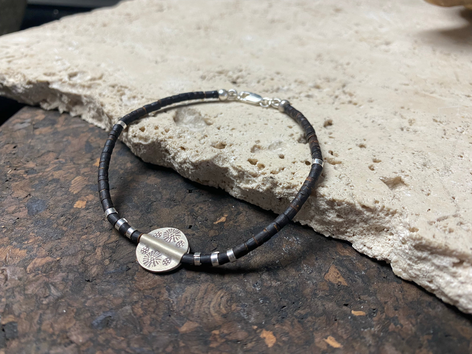One of our signature coconut silver bracelets, crafted from polished coconut wood and hill tribe 95% silver., with sterling silver lobster clasp. A women's bracelet or a men's bracelet, it has a casual Boho vibe, and is made for that stacked bracelet look. Different sizes available