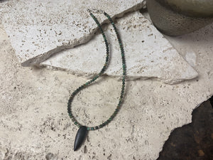 Fine unisex necklace of round natural stone beads, highlighted with Karen hill tribe sterling silver "eye beads" and a long pendant of unpolished onyx. The effect is simple and stunning. Finished with sterling silver findings and hook clasp. Length 42 cm