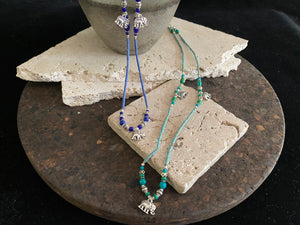 Beaded stone elephant necklace in either turquoise or lapis blue, each featuring three small elephant charms. This beautiful stone necklace is indistinguishable from much more expensive sterling silver and natural turquoise or lapis necklaces. This is unisex jewellery that can be worn either as a bracelet or as a necklace
