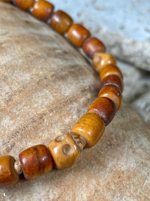 Carved vintage yak bone bead bracelet features carved skull beads and tiny sandalwood spacer beads. Unique and beautiful. Stretchy cord, wear alone or stacked with other bracelets for a classic boho look. Two sizes, 20 cm and 18 cm. Unisex jewellery for men or women.