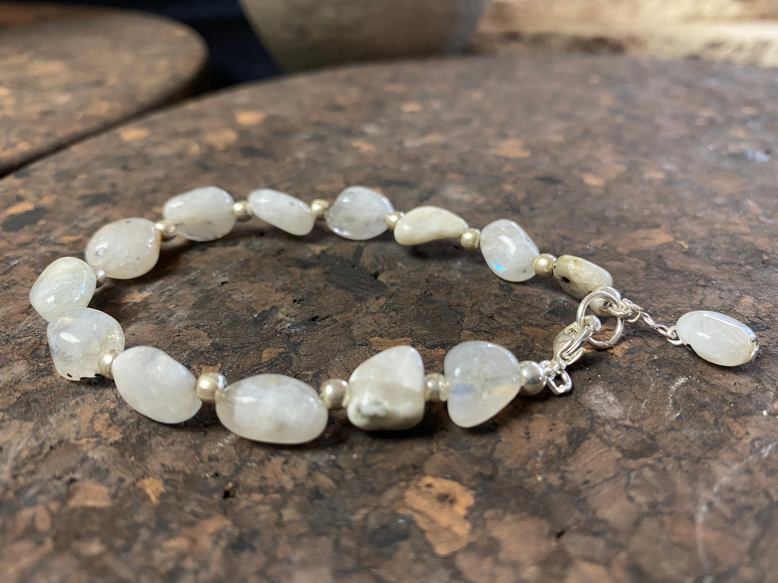 Boho style bracelet made from natural rainbow moonstone stones, finished with sterling silver. A single moonstone drop acts as both a feature to catch the eye and as a counterweight, keeping the bracelet sitting the right way up on the wrist.  18.5 cm length (7.3")