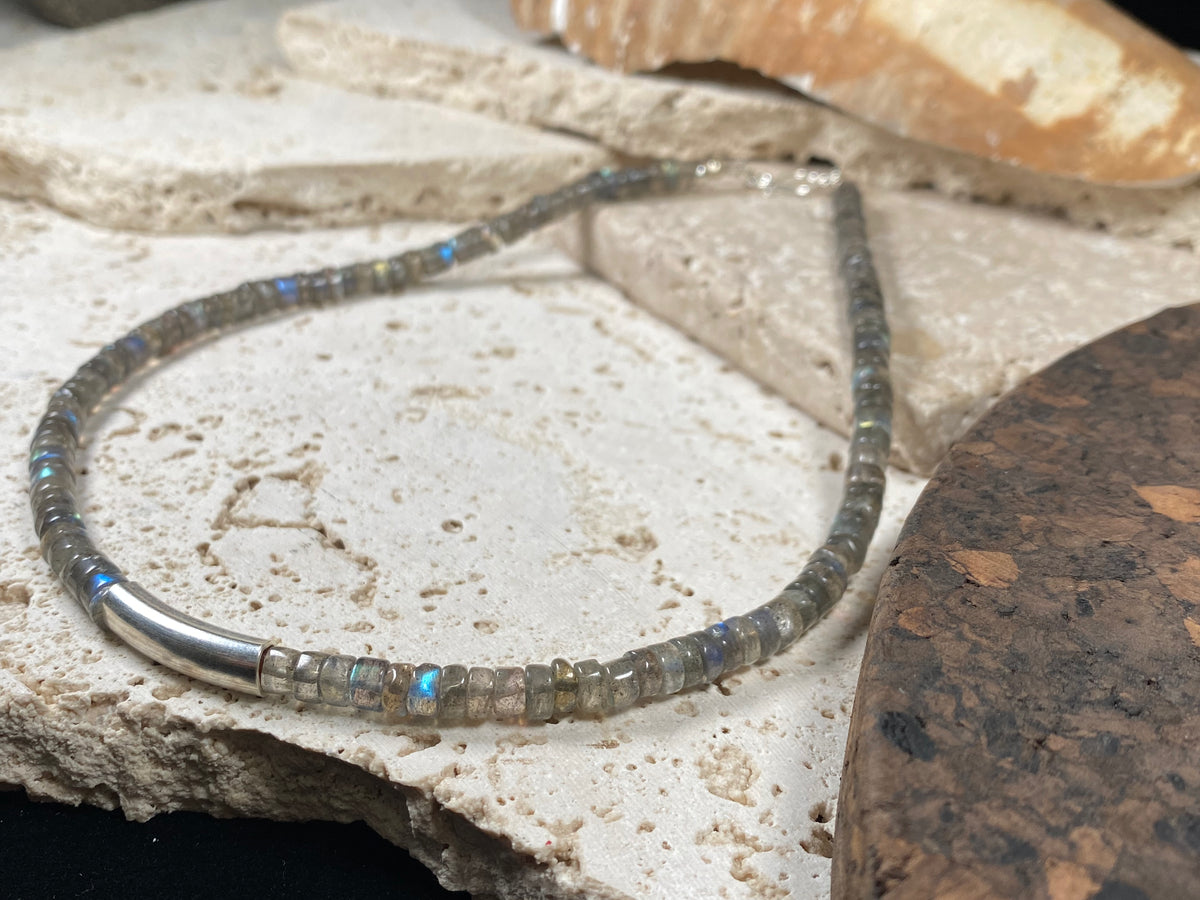 Striking choker necklace of rondel-cut labradorite, highlighted with a central sterling silver pendant bead. This necklace is finished with a sterling silver hook clasp. Length 42 cm