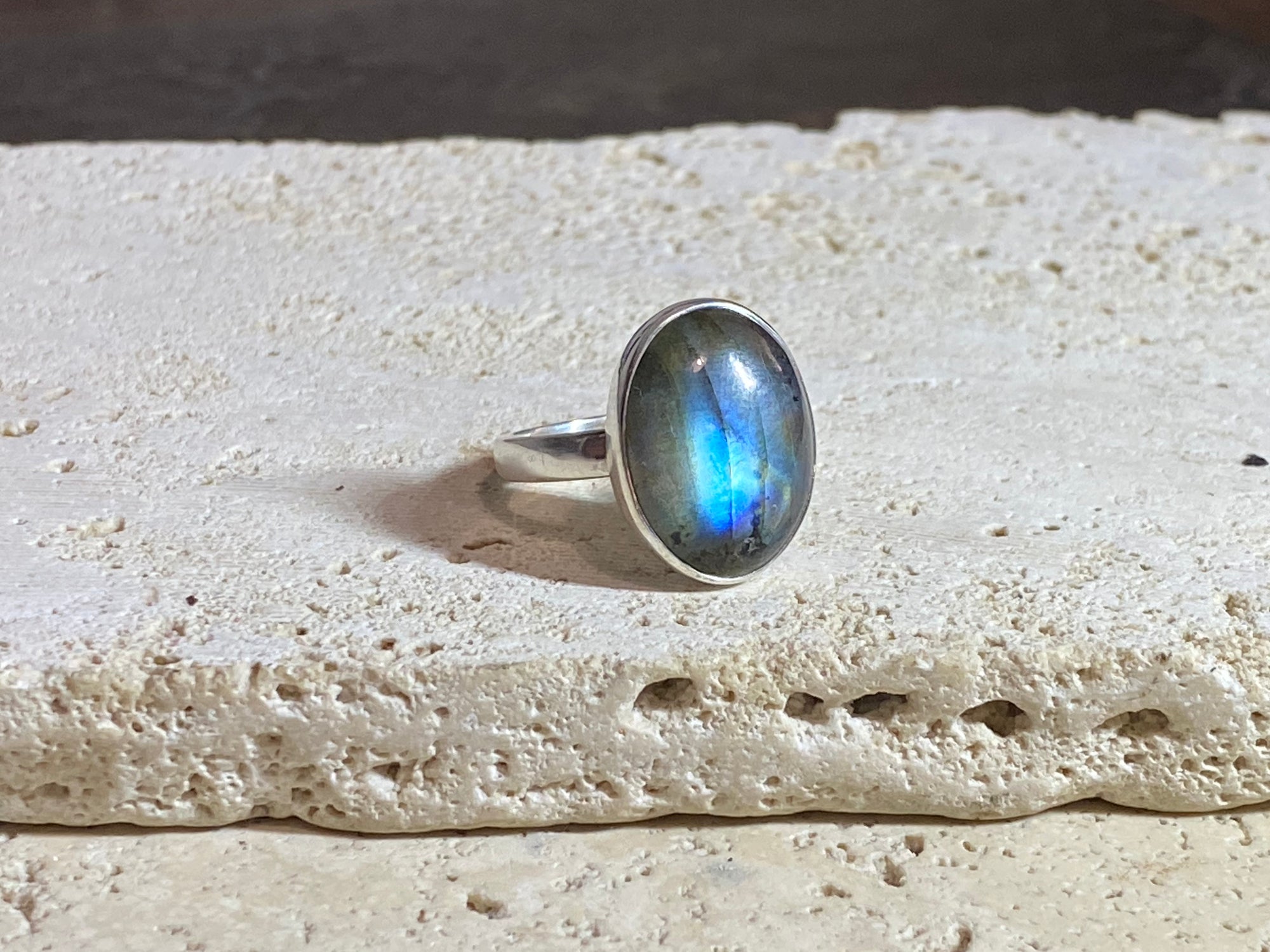 Round oval labradorite ring set in sterling silver. A high quality stone with green, blue and orange fire.  Size 7.5