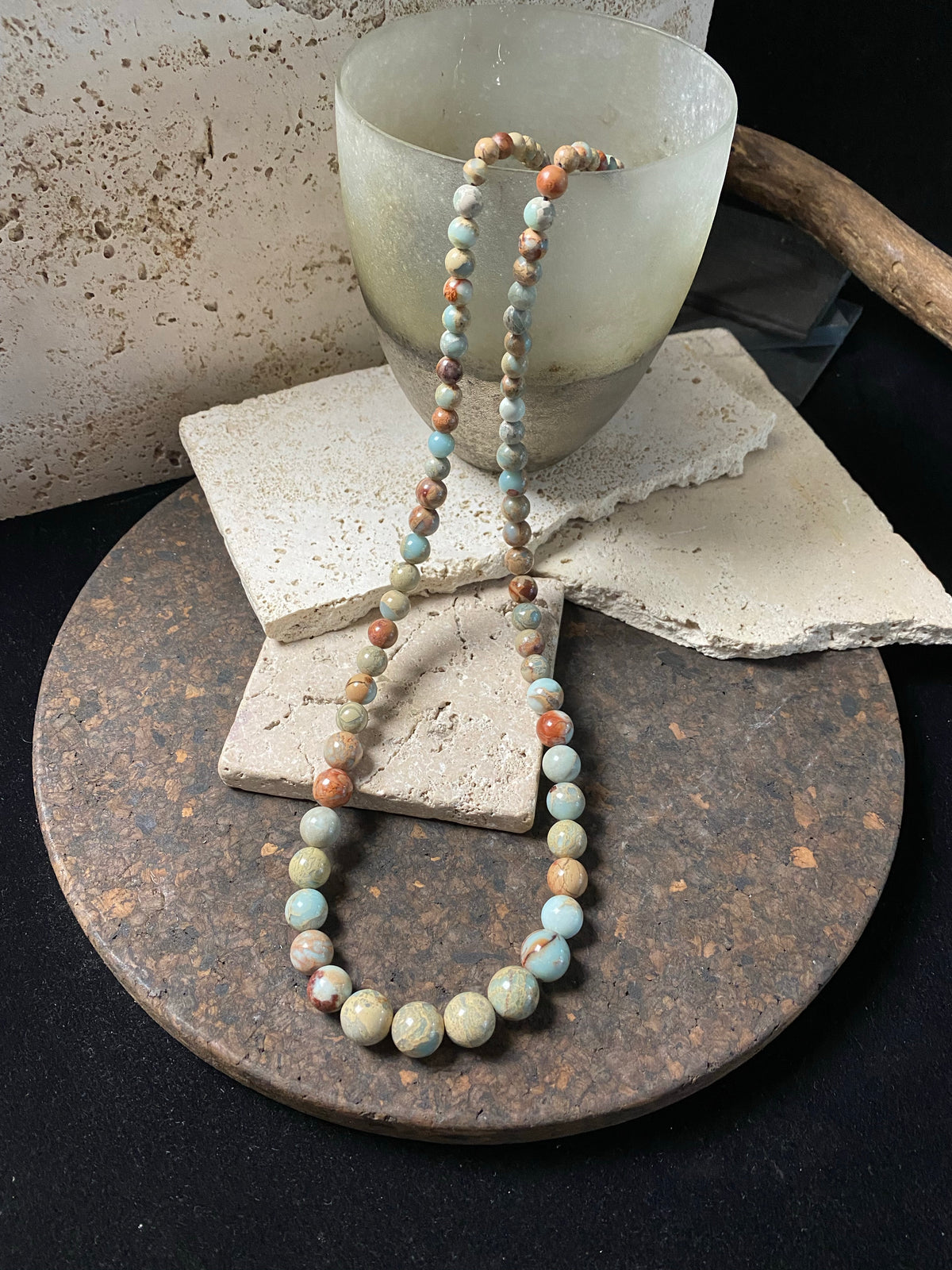 A long necklace made from perfectly matched, graduated Ethiopian opal beads, finished with sterling silver findings. Hook clasp. Measurements: 80 cm (31.5"), largest bead 14 mm diameter, smallest bead 6 mm diameter.