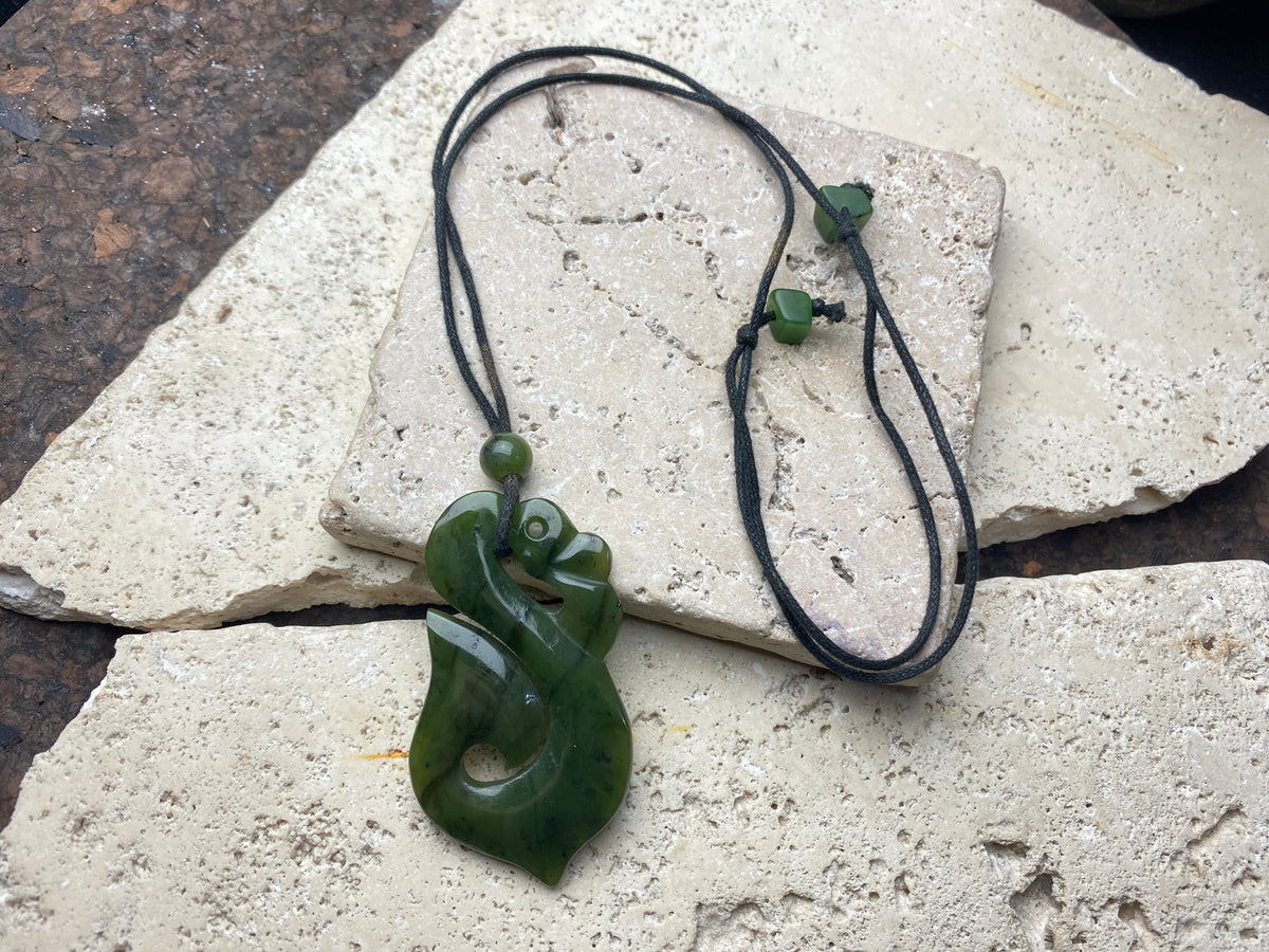 Stunning natural light green veined jade Maori guardian Manaia pendant